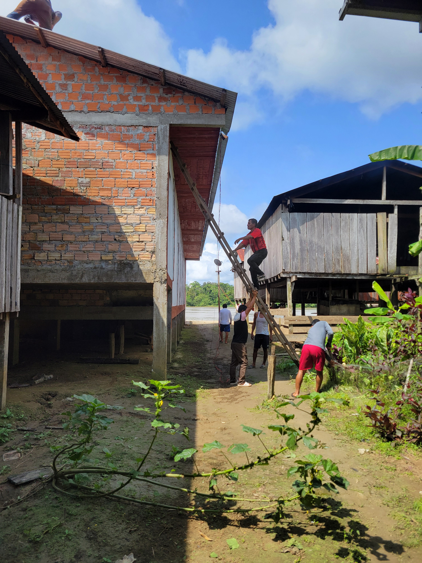 People working together on a building project in a riverside community